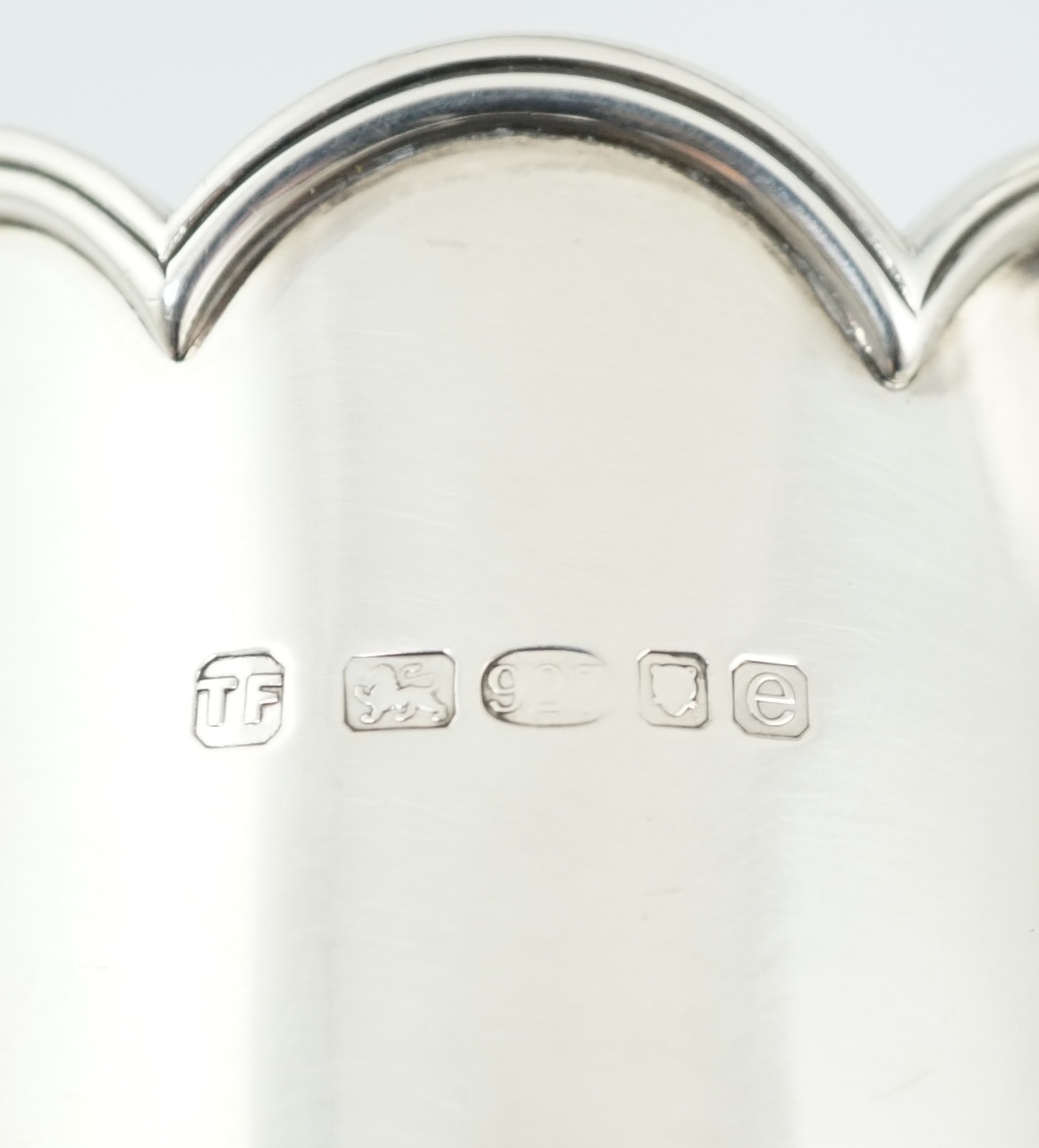 Three assorted Elizabeth II Theo Fennell silver bottle holders